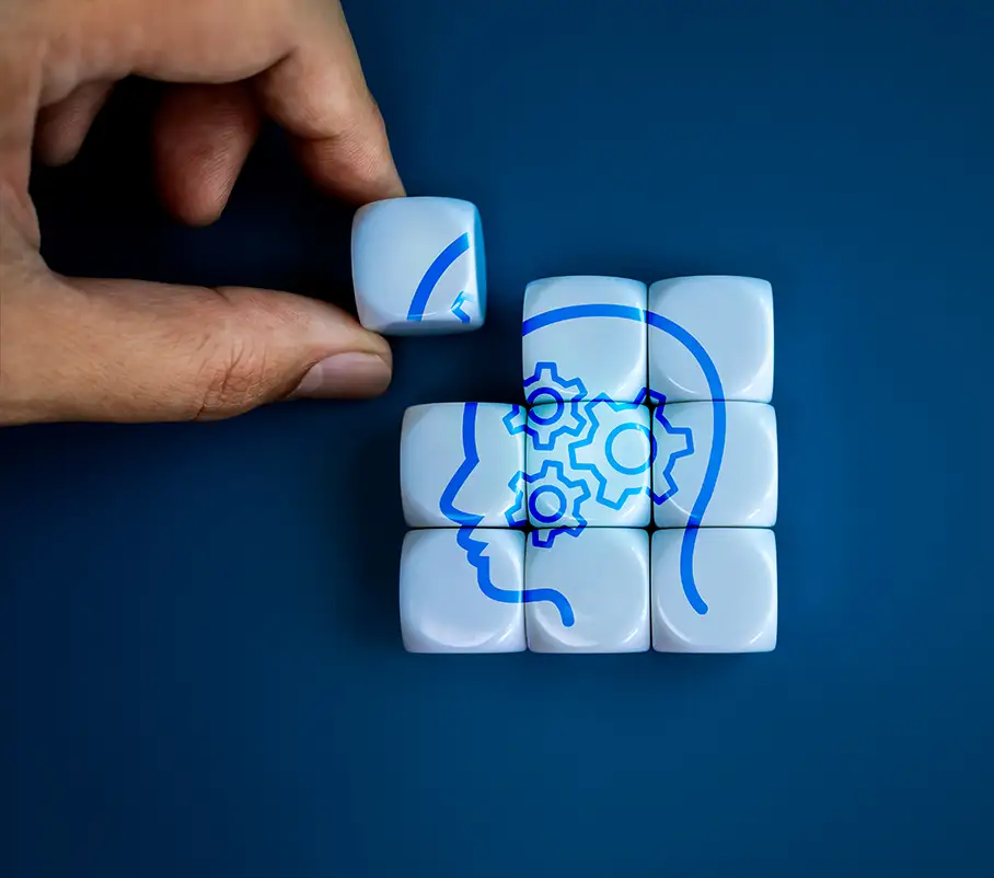 business solution creative invention innovative concepts gears cogwheels icon human head shape graphic white cube blocks puzzle hand put last one complete blue background copy